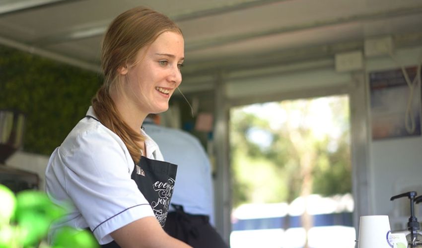 Senior School student serving coffee from Valley Connect Café